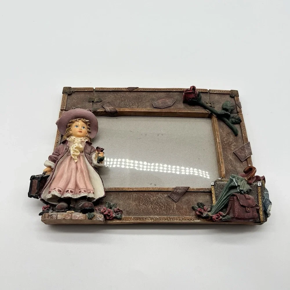 A Richesco Corporation Girl With Roses Suitcase Hand Painted Resin picture frame